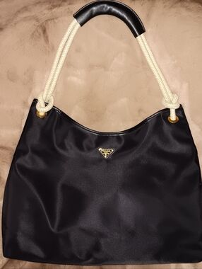 Prada Black Nylon NWOT"" Shoulder Bag with Cream Rope Handles and Gold Logo.